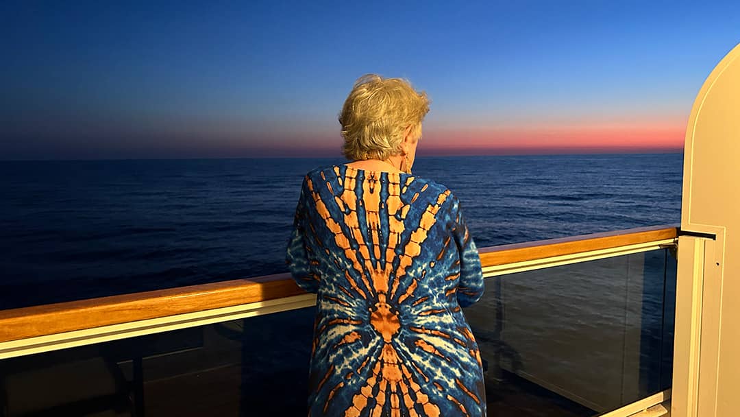 Guest relaxing on the deck of a seabourn cruise ship at sunset - the essence of ultra-luxury cruising